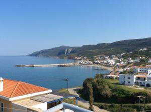 a view of a town and a body of water at Zathea Apartments in Agia Pelagia