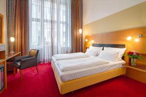 Posteľ alebo postele v izbe v ubytovaní Theatrino Hotel