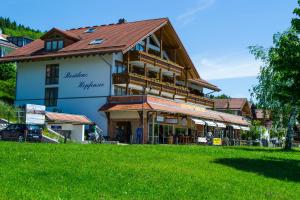 un grand bâtiment au milieu d'un champ verdoyant dans l'établissement Residenz Hopfensee, à Füssen