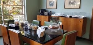 a dining room with a table with food on it at Villa Gotti Charming Rooms in Bologna