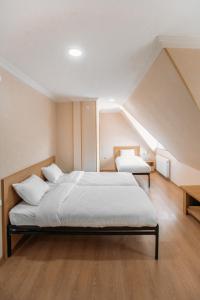 a bedroom with a bed in a attic at Royal Bakuriani in Bakuriani