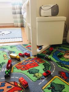 a childs room with a toy train on a rug at Kleine Harzzeit in Hahnenklee-Bockswiese