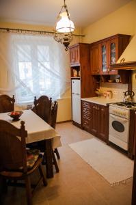 a kitchen with a table and a white stove top oven at Apartament Parkowy in Sandomierz