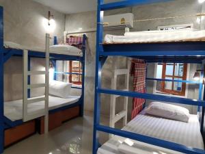 a group of bunk beds in a room at Sun smile(cafe & homestay) in Ubon Ratchathani