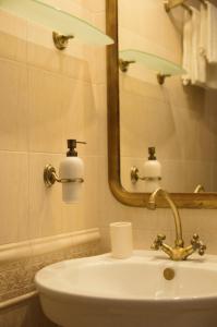 ein weißes Badezimmer mit einem Waschbecken und einem Spiegel in der Unterkunft Apartament Parkowy in Sandomierz