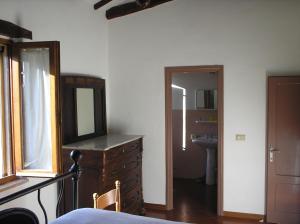 a bedroom with a dresser with a mirror and a sink at podere San Giuseppe in Cetona