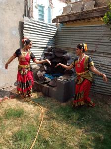 two women standing in front of a grill at Godavari Lodge in Solapur