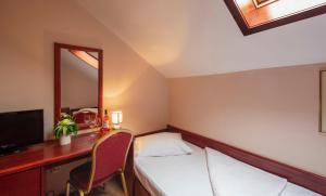 
a hotel room with a bed and a desk at B&B Garestin in Varaždin
