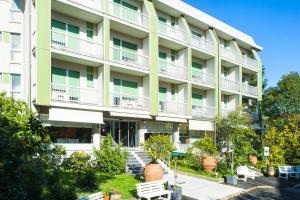 un condominio con panchine di fronte di Hotel Ghironi a La Spezia
