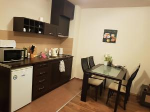 a small kitchen with a table and a microwave at Katy's studio in Bansko
