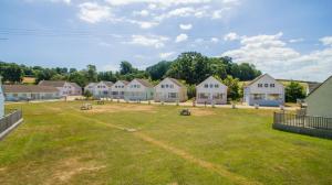 a group of houses in a field with a yard at Seaview Holidays - Salterns Village in Seaview