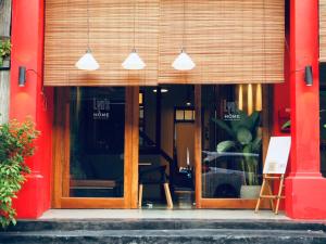 a store front with glass doors and pendant lights at Yu Cafe Hostel in Songkhla