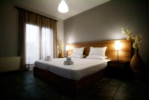 a bedroom with a bed with two teddy bears on it at Limni Hotel in Fanari