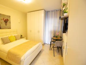 a bedroom with a bed and a table and a television at Dira BaLev in Eilat