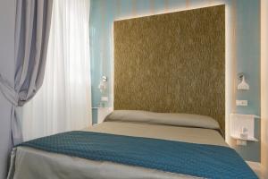 A bed or beds in a room at Cavour Suites Guest House