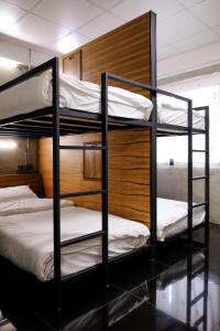 a bunk bed with two bunk beds in a room at Baan Lung Poshtel in Chiang Mai