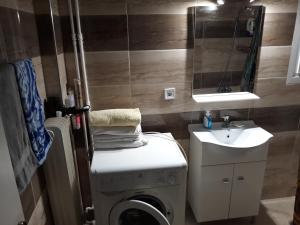 a bathroom with a washing machine and a sink at Apartment on Dimitrakopoulou in Athens