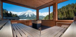 a large room with a view of mountains at Tirol Lodge in Ellmau
