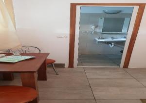 a bathroom with a sink and a table and a mirror at PENSIUNEA CARAIMAN Servicii de cazare in Codlea +36 photos