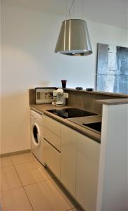 a kitchen with a stove and a dishwasher at TADO in Kamiesch