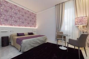 A bed or beds in a room at Cavour Suites Guest House