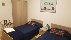 a bedroom with two beds and a desk at Etna Parking in Catania