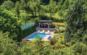 an aerial view of a backyard with a pool and a gazebo at Holiday home/apartments Vaska in Moravice