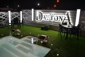 a restaurant with a table and chairs next to a pool at Hotel Daytona Palace in Casoria