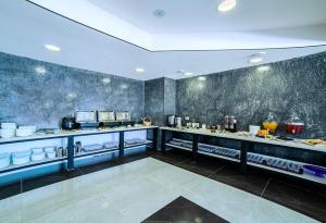 a restaurant with a counter with food on it at Amiran's Park in Bakuriani