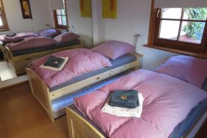 a room with four bunk beds with pink sheets at Welcome House in Wendlingen am Neckar