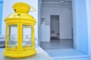 a yellow lantern sitting on top of a table at Sopravento House in Serifos Chora