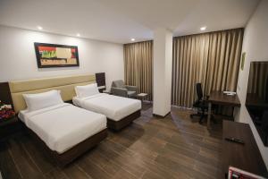 Postel nebo postele na pokoji v ubytování Jaag Hotel