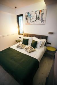 a bedroom with a large bed with two pillows at Briana Luxury Studio in Cluj-Napoca