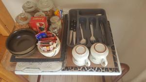 a tray with shoes and utensils on a table at Aloes Bush Stay in Hoedspruit