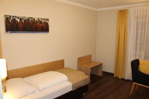 Postel nebo postele na pokoji v ubytování Hotel Brauereigasthof Amberger