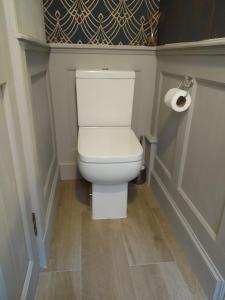 a bathroom with a toilet with a roll of toilet paper at The Old Endie Hoose Kirkwall Orkney in Kirkwall