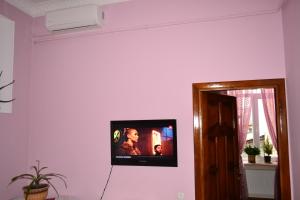a flat screen tv on a wall in a room at Apartment on Shevchenka Boulevard in Ternopil