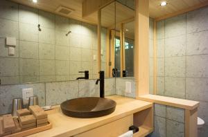 a bathroom with a wooden sink and a mirror at Reikaku Yasaka in Kyoto +33 photos