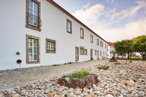 a large white building with a stone driveway at Convento do Seixo Boutique Hotel & Spa in Fundão