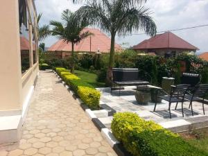a patio with chairs and a tv in a yard at Ikaze B&B in Kigali