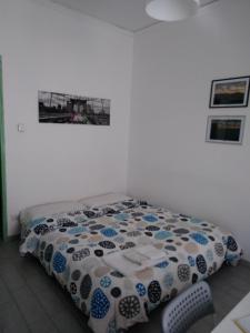 a bedroom with a bed with a quilt on it at Il Cortiletto in Castelbuono