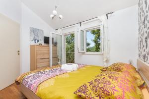 a bedroom with a large bed and a window at HIDDEN PARADISE - Villa by Split in Žrnovnica +49 photos