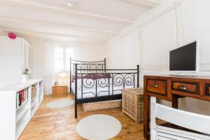 a bedroom with a bed and a television in it at Kleine Fachwerkwohnung in Alfter