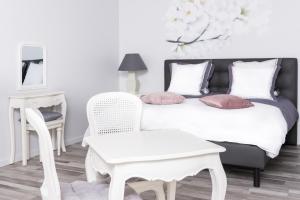 1 dormitorio con 1 cama, 1 mesa y 1 silla en L'Attrap'Rêves : Le confort Hôtelier, la convivialité en plus, en Ergersheim