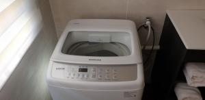 una lavadora con la puerta abierta en el baño en Dawn's Place, en Strand