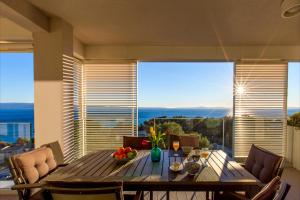 a dining room table with a bowl of fruit on it at Bel Etage Amora Luxury Seaview Apartment with pool in Split
