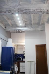 a kitchen with wooden ceilings and a blue refrigerator at Gmax Guelfa Apartments in Florence