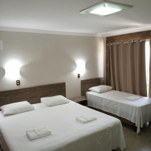 Un ou plusieurs lits dans un hébergement de l'établissement Hotel Iguassu Inn
