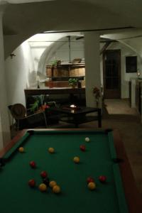 a pool table with balls on it in a living room at Le Moulin Des Ocres in Apt