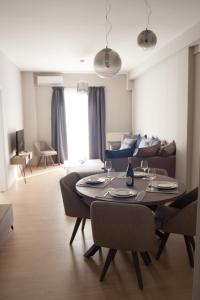 a living room with a table and a couch at Stylish Zoi's appartment next to HELEXPO, White Tower in Thessaloniki